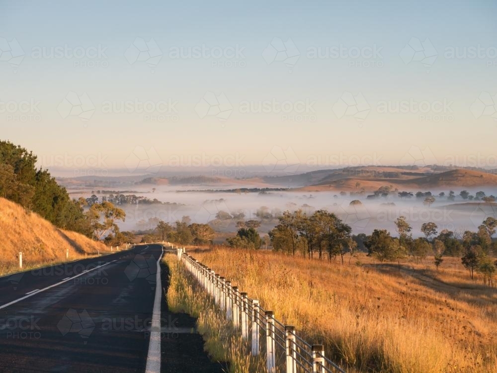 Oxley Highway approaching from the east of Walcha just after sunrise - Australian Stock Image