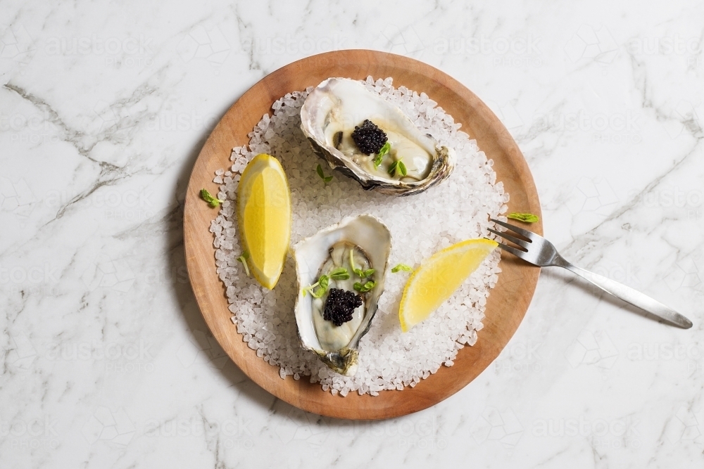 Oysters, topped with caviar on a plate - Australian Stock Image