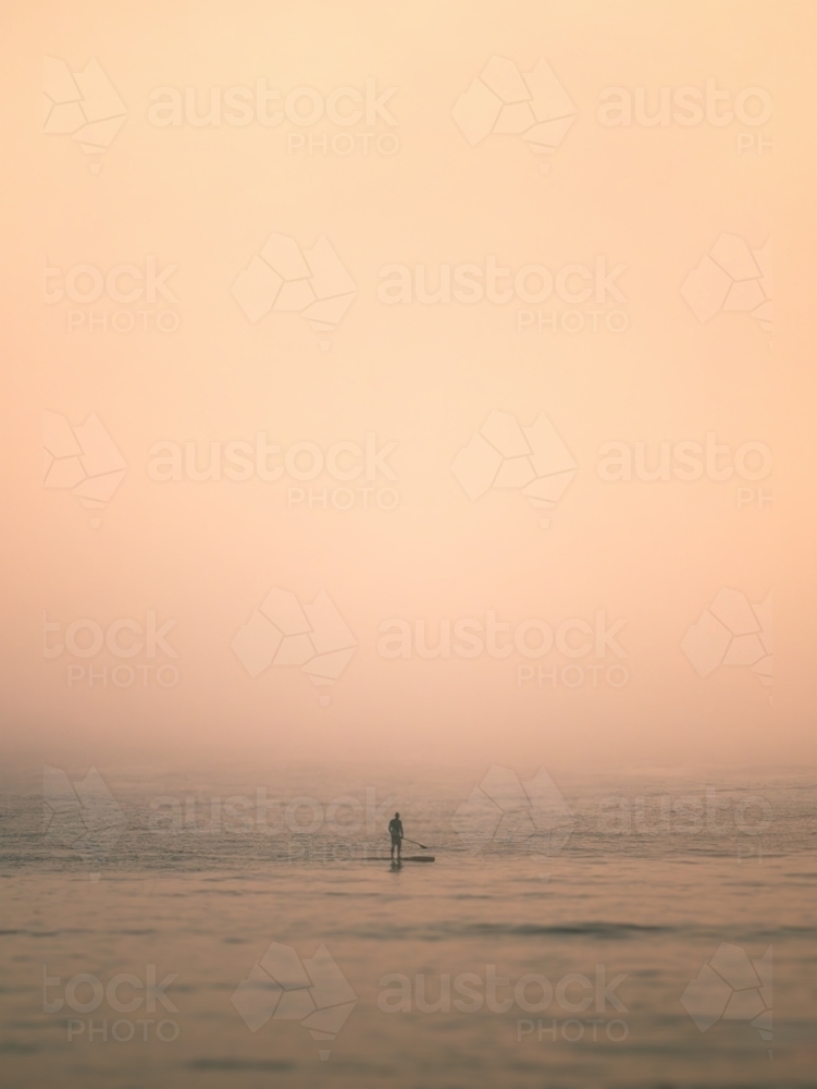 Paddleboarder in Heavy Fog on the Ocean - Australian Stock Image