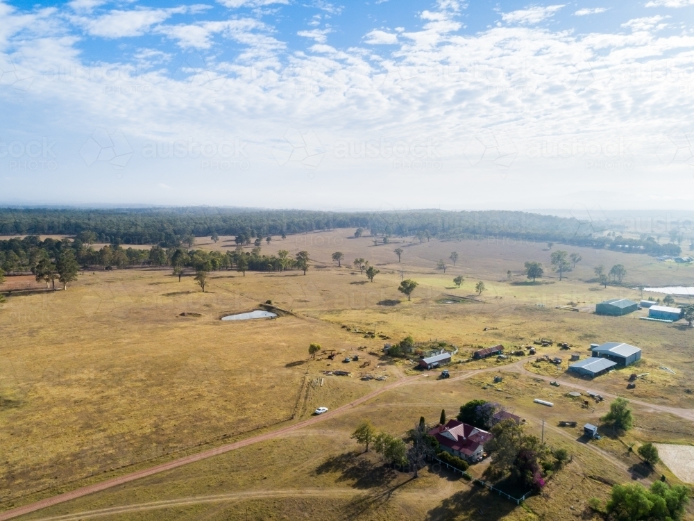 Image of paddocks of cattle farm with house and sheds - Austockphoto