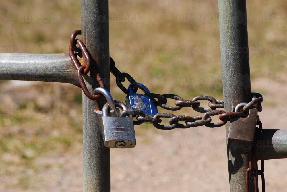 Padlocks and chain around a paddock gate - Australian Stock Image