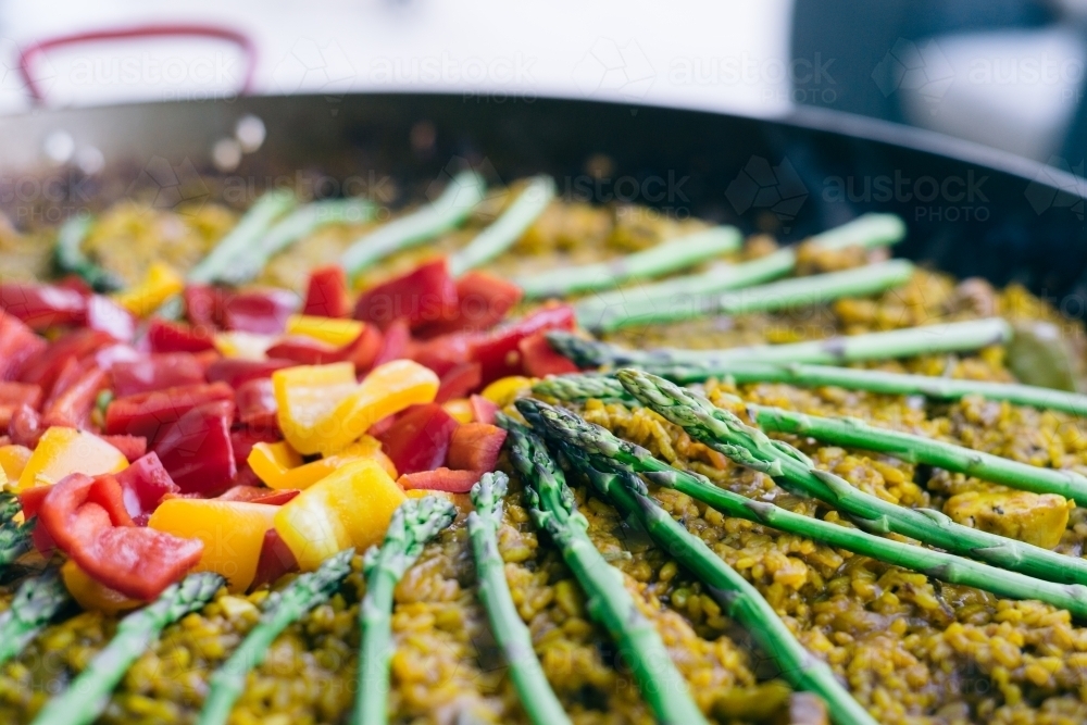 paella, close up on the asparagus and capsicum - Australian Stock Image