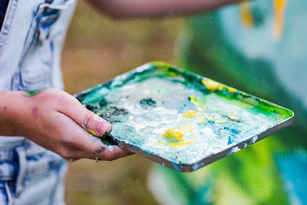 Image of Paint tray for mixing colour in artists hand Austockphoto