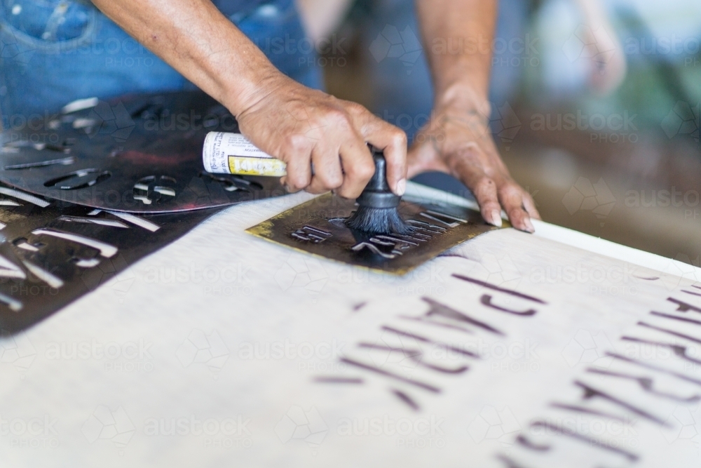 Painting stencil on wool bale - Australian Stock Image