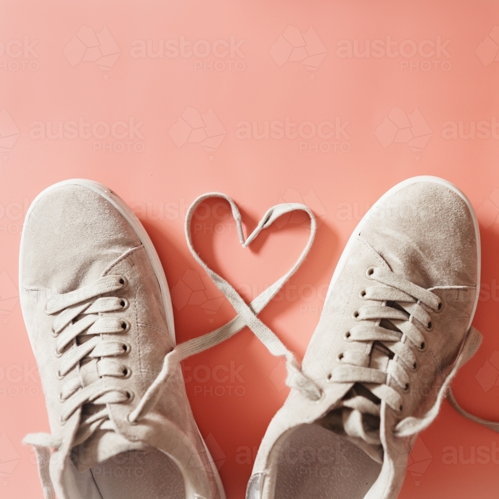 Pair of grey runners with laces making a heart shape - Australian Stock Image