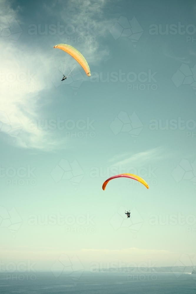 Pair of parachutes / parasailers on a clear day - Australian Stock Image