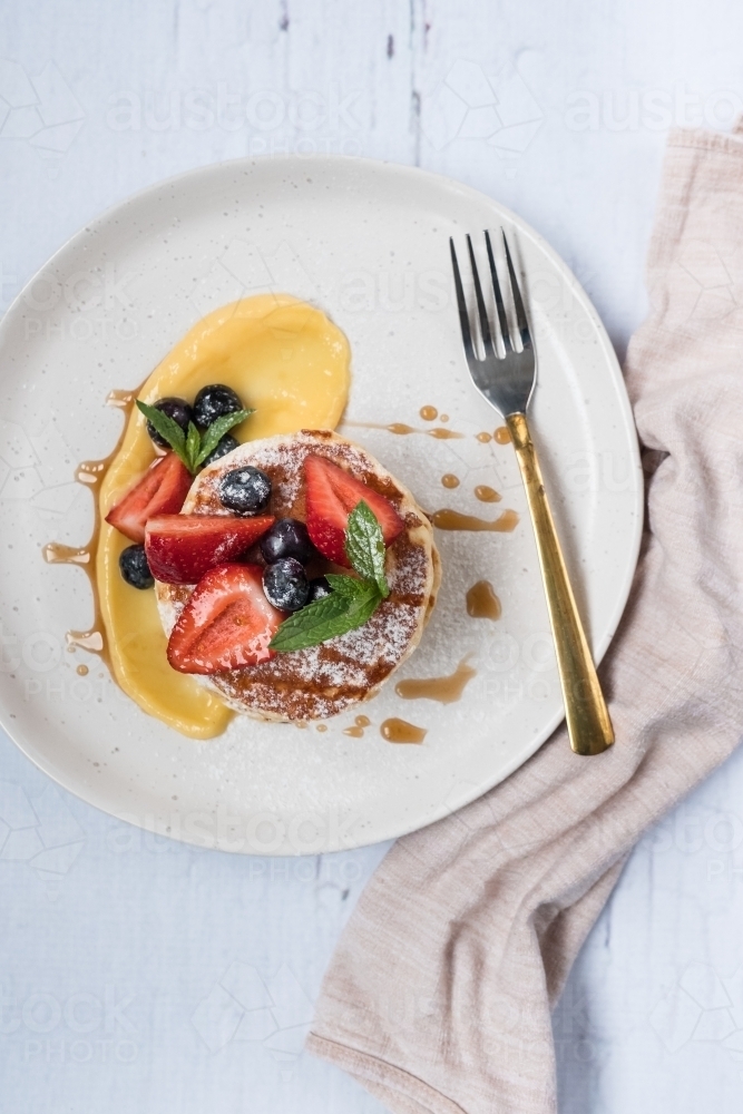 Pancake stack with lemon and berries. - Australian Stock Image