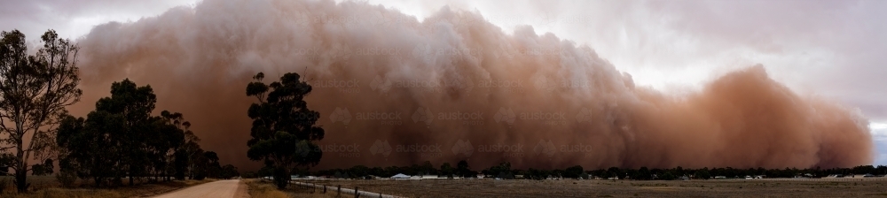 panorama of dust storm rolling in over small town - Australian Stock Image