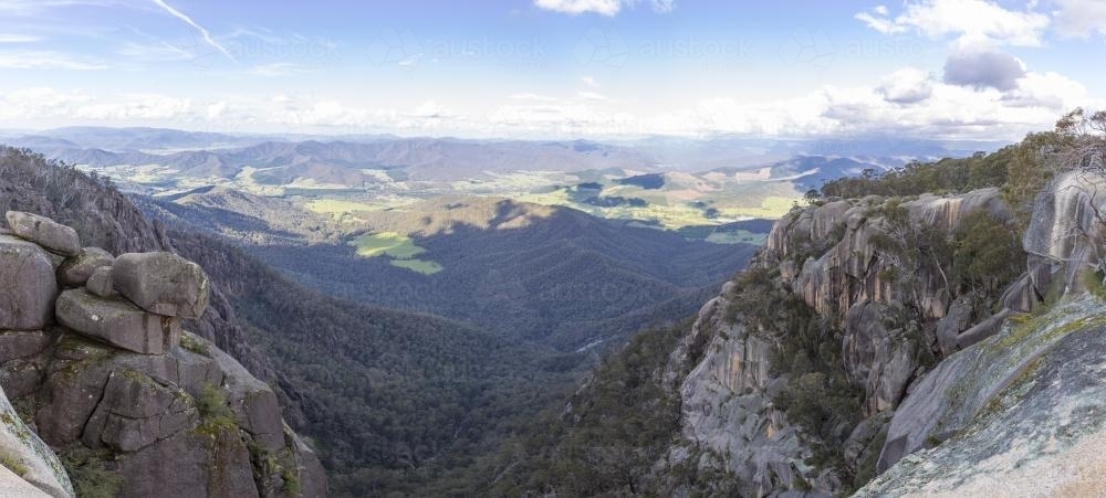 Panorama of high country valley from rocky clifftop - Australian Stock Image
