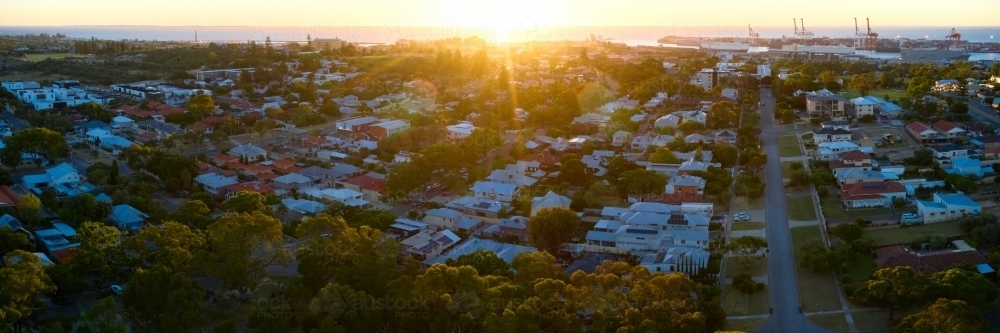 Panorama of the sun setting on the ocean's horizon behind Fremantle City - Australian Stock Image