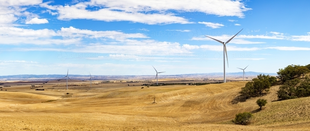 Panorama of wind towers in farming landscape - Australian Stock Image