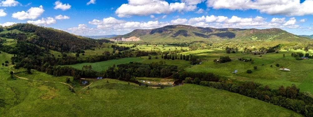 Panorama shot of mountains and field - Australian Stock Image