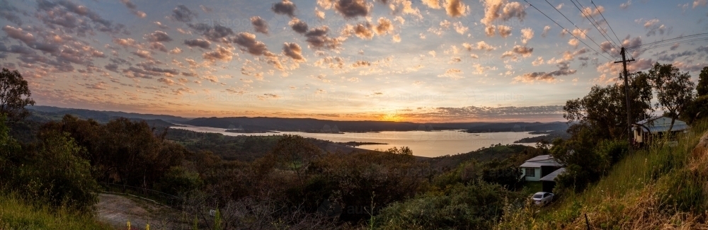 Panorama view of a morning sunrise over a lake - Australian Stock Image
