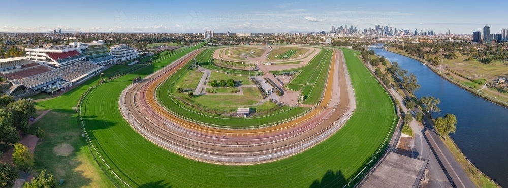 Panoramic aerial view of a wide bend on a horse racing track with a river running along side - Australian Stock Image