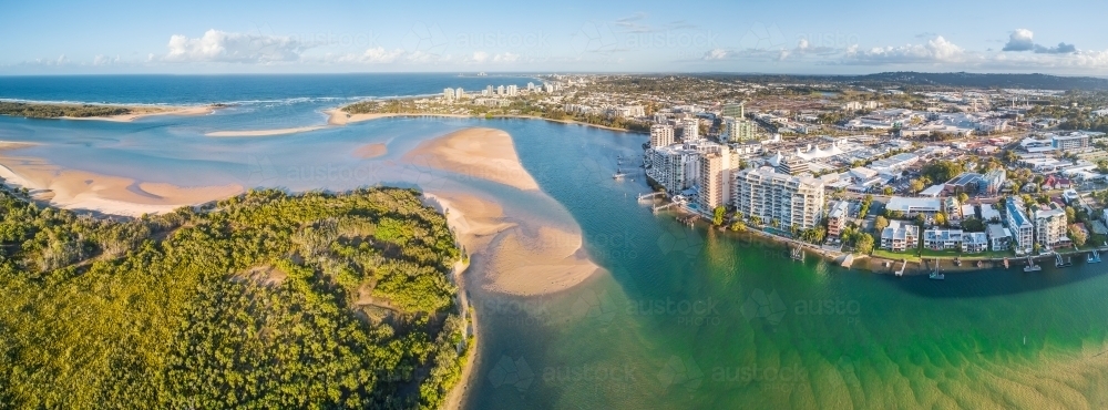 Panoramic aerial view of mangroves and real estate along the banks of the Maroochy River in Queensla - Australian Stock Image