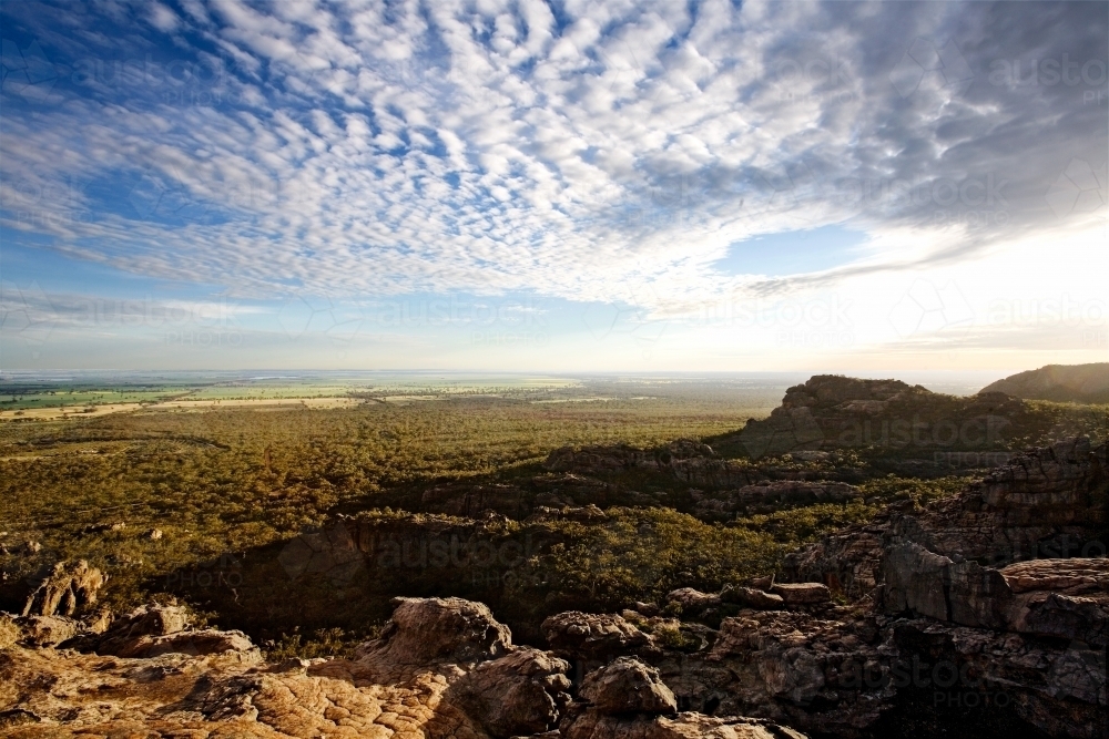 Panoramic view from mountain across valley in late afternoon - Australian Stock Image