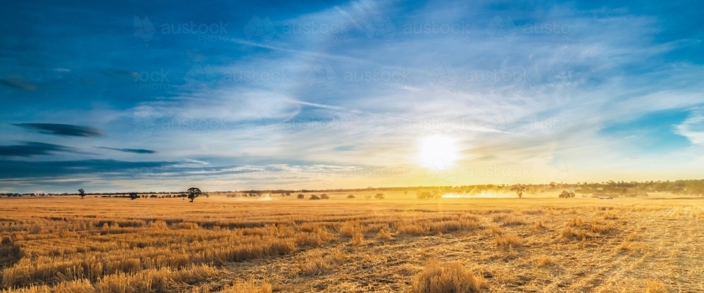 Panoramic view of the outskirts of a rural farming town at sunset - Australian Stock Image