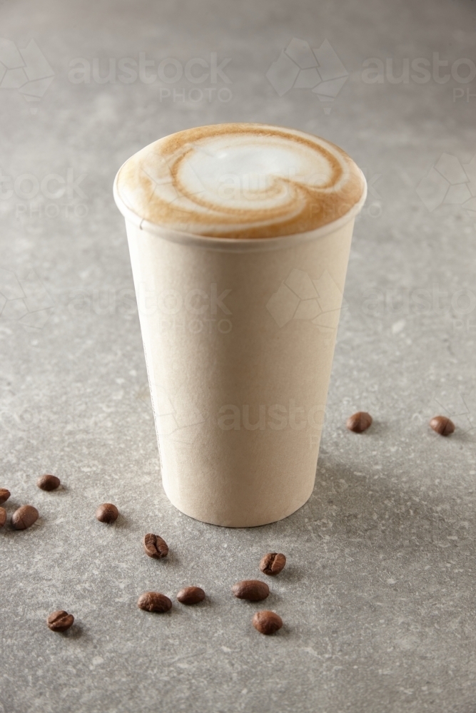 Paper coffee cup and coffee beans on table : Austockphoto Paper coffee cup and coffee beans on table - Australian Stock Image