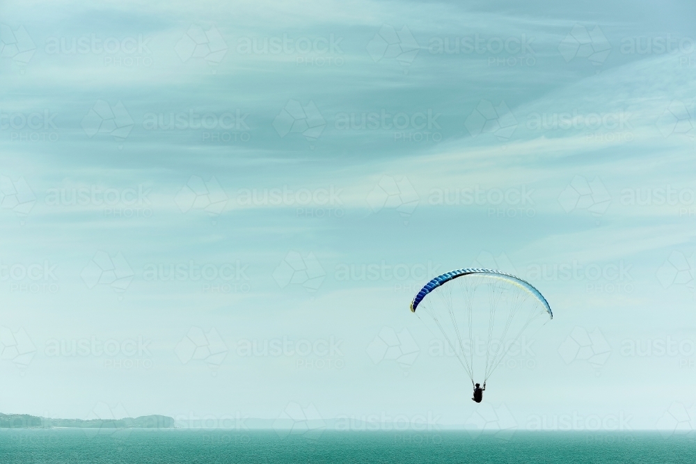 Paragliding into a beautiful sky alone - Australian Stock Image