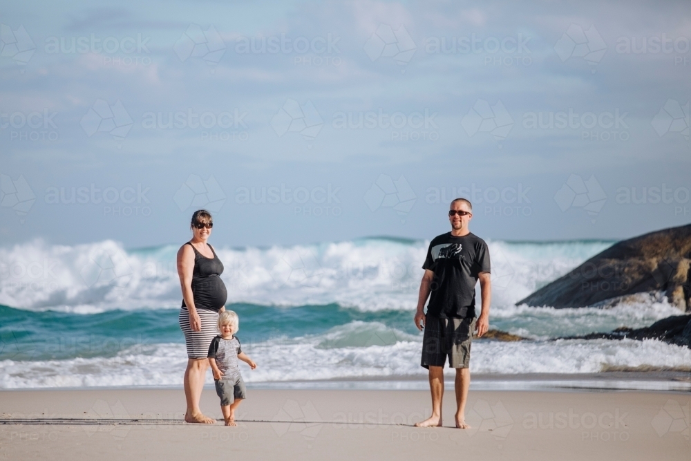 Parents and toddler on the beach, and the woman is pregnant - Australian Stock Image
