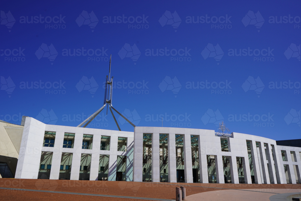 Parliament House under blue sky on bright day - Australian Stock Image