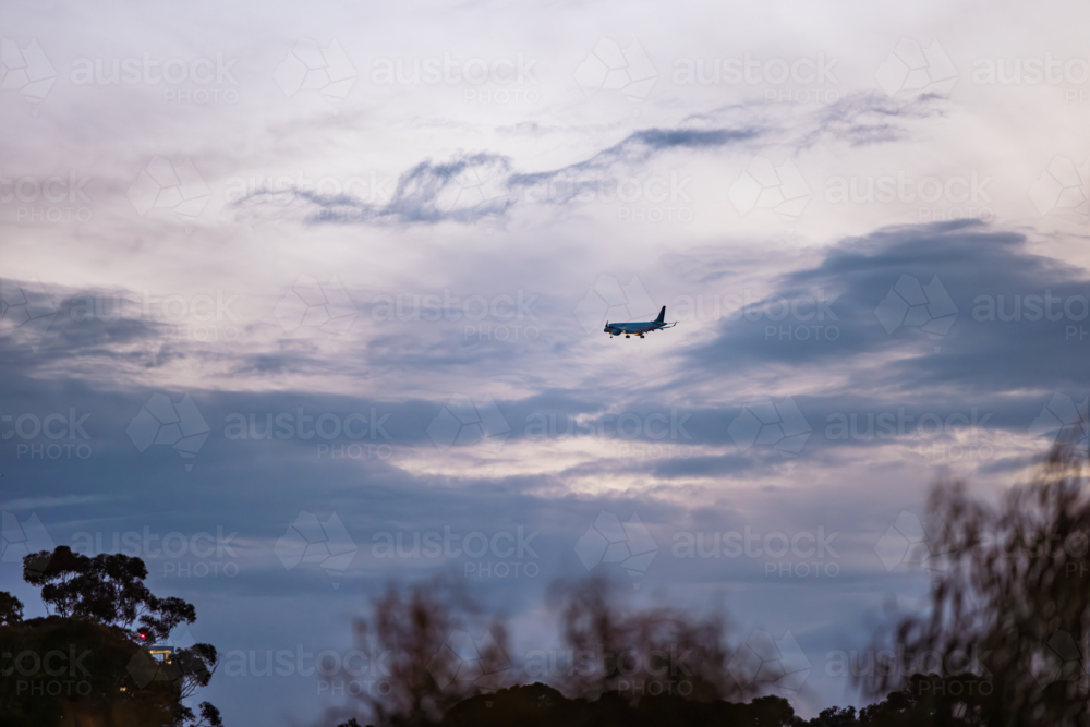 Passenger plane preparing to land at Adelaide Airport in the evening - Australian Stock Image