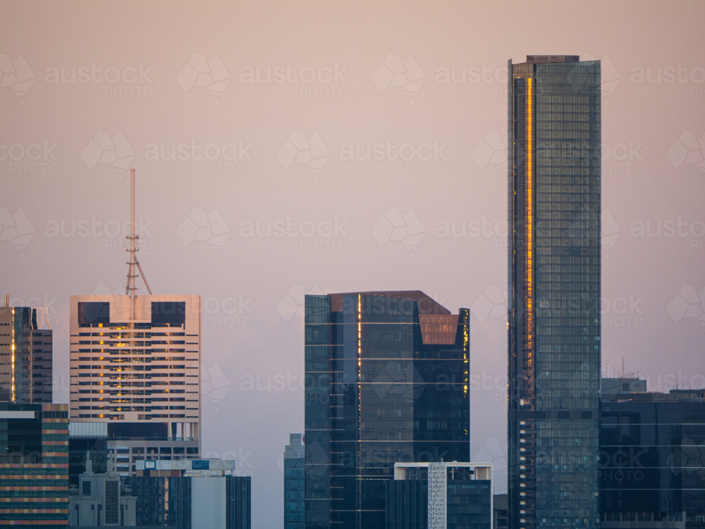 Pastel coloured sky over city skyline. - Australian Stock Image