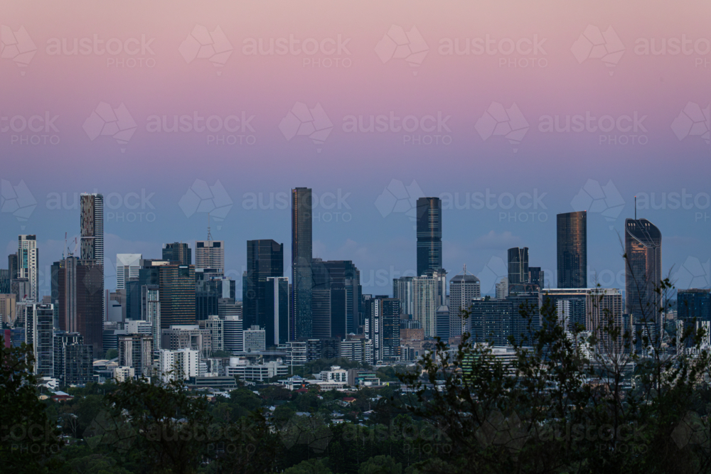 Pastel coloured sky over city skyline - Australian Stock Image