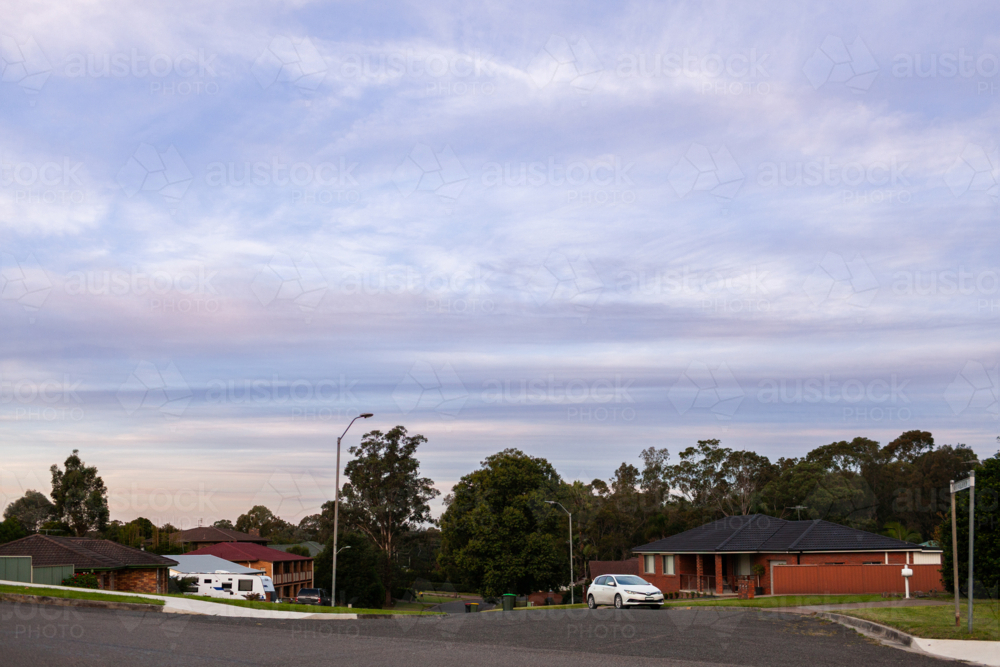 pastel dusk sky over streetscape of residential area of country town - Australian Stock Image