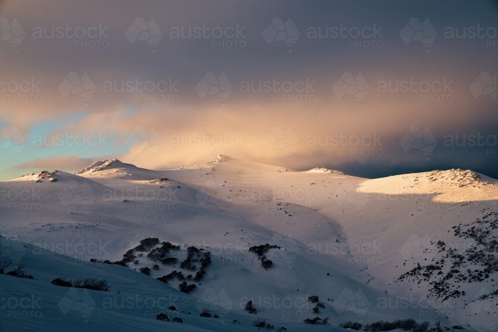 Pastel last light sunset over Mount Tate Snowy Mountains - Australian Stock Image