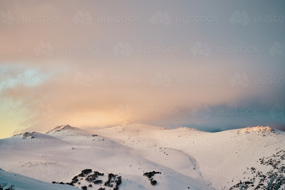 Pastel sunset over Mount Tate Snowy Mountains - Australian Stock Image