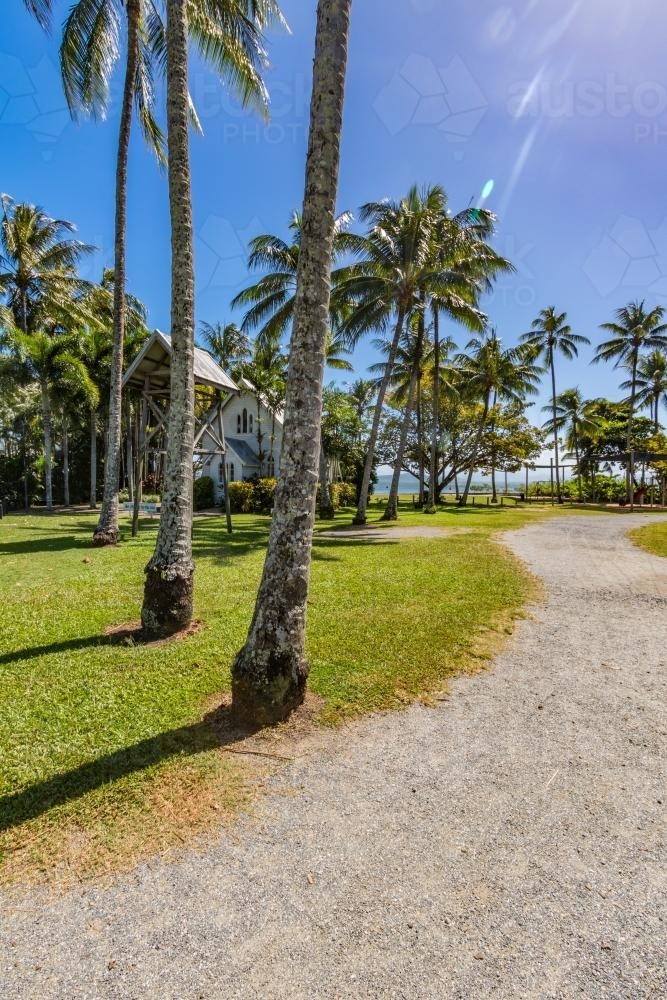 Path leading to St Mary's by the sea with palm trees - Australian Stock Image