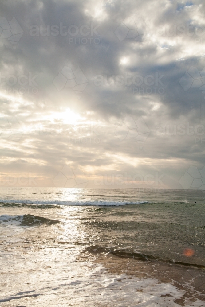 path of light over the ocean at sunrise - Australian Stock Image