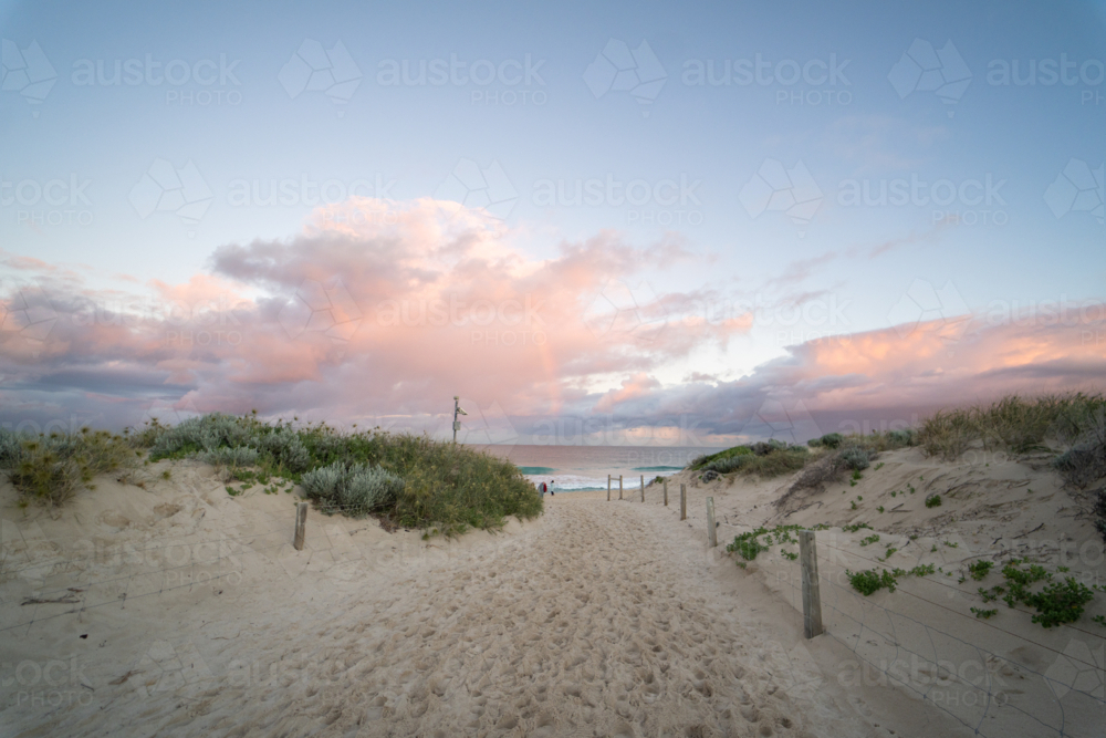 Pathway and coastal sand dunes, pastel sunset sky at Scarborough Beach, Perth, Western Australia - Australian Stock Image