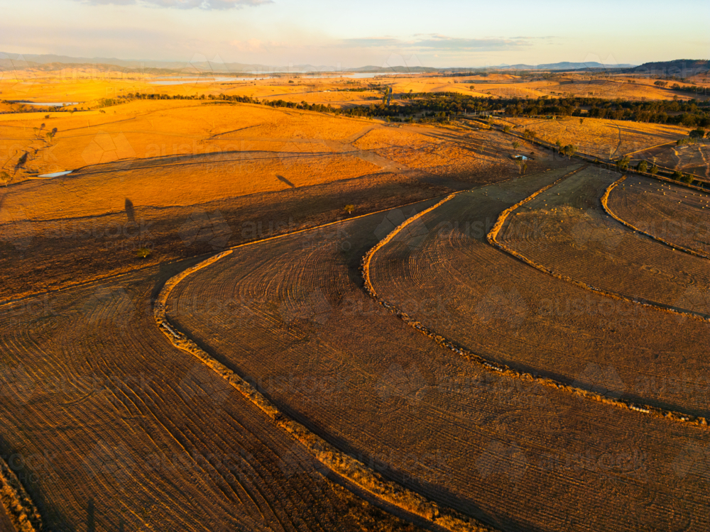 Patterns on the ground after machines have cut grass in a paddock - Australian Stock Image