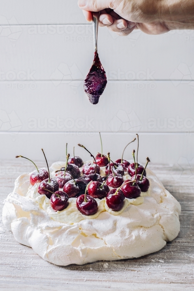 Pavlova topped with cherries - Australian Stock Image