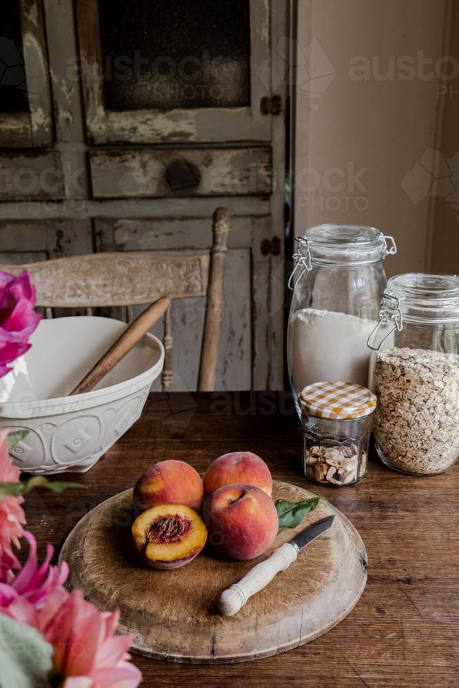 peaches ready for baking in a vintage style kitchen - Australian Stock Image