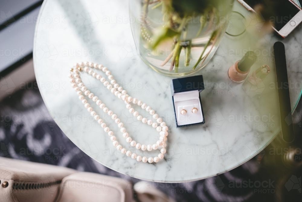 Pearl jewellry on a marble side table - Australian Stock Image