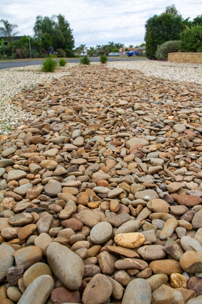Pebbles in dry creek bed drain - Australian Stock Image