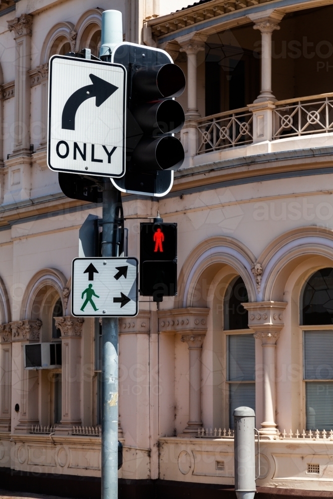 Pedestrian crossing light at traffic lights with right turn only sign - Australian Stock Image