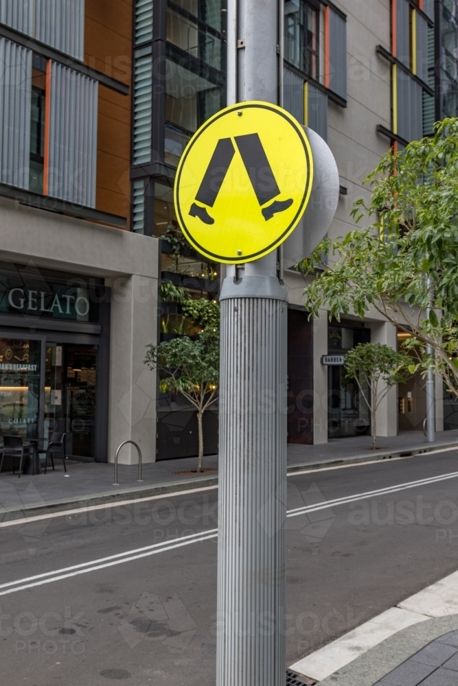 Pedestrian crossing sign on city street - Australian Stock Image