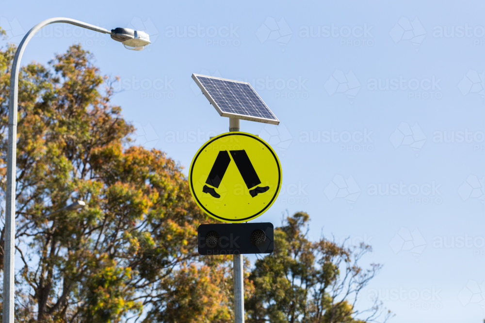 Pedestrian crossing sign with warning lights powered by solar panel - Australian Stock Image