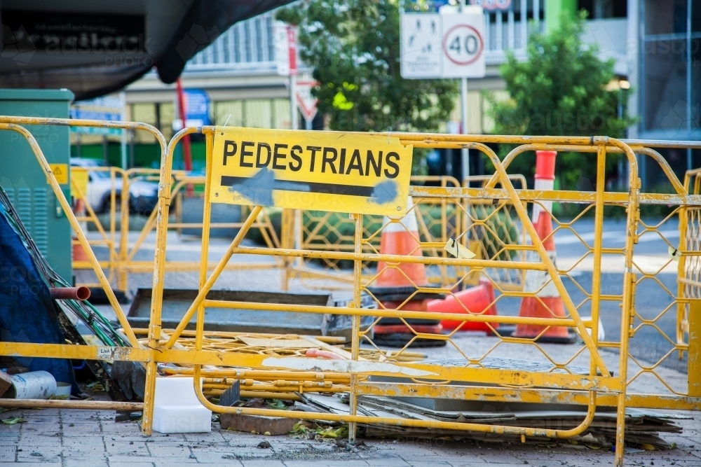 Pedestrians sign with barrier fence around urban roadwork - Australian Stock Image