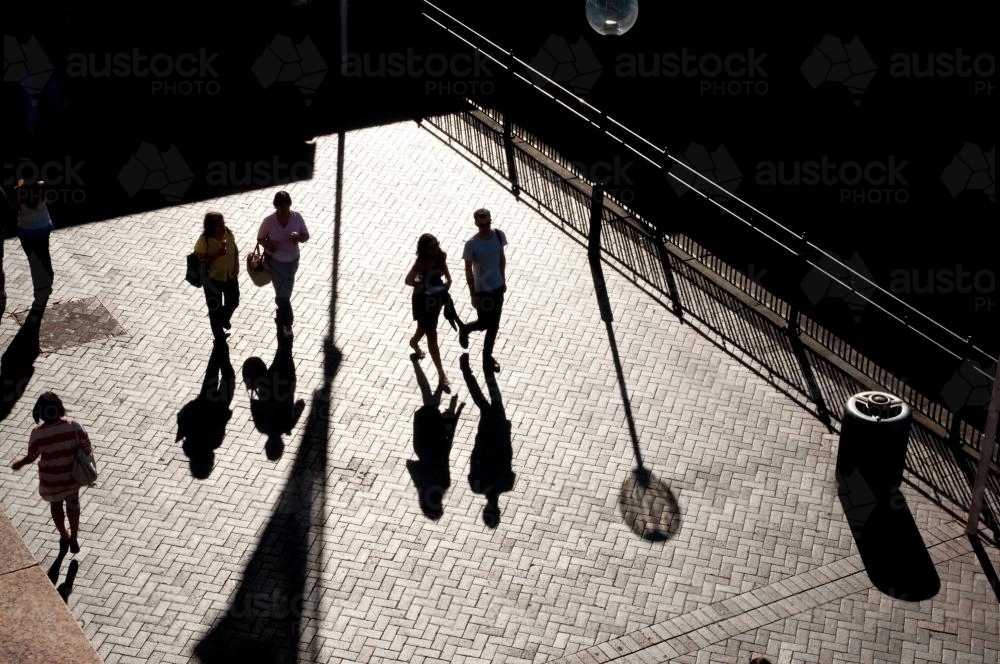 Pedestrians with long shadows at Circular Quay - Australian Stock Image