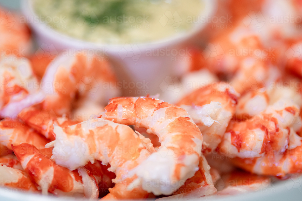 peeled prawns in a bowl, vibrant striped tiger prawns - Australian Stock Image