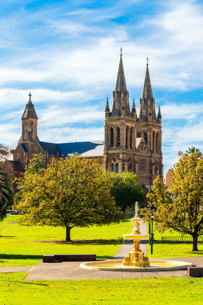 Pennington Gardens fountain with the St. Peters Cathedral in background in Adelaide on a day - Australian Stock Image