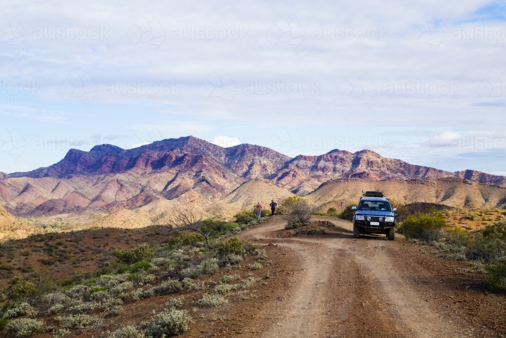People and four wheel drive at a look out over rugged mountains - Australian Stock Image