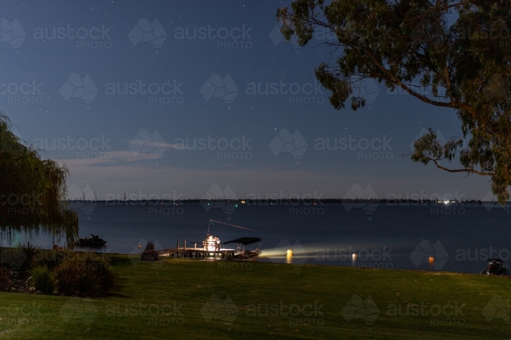 People fishing at night on lake - Australian Stock Image