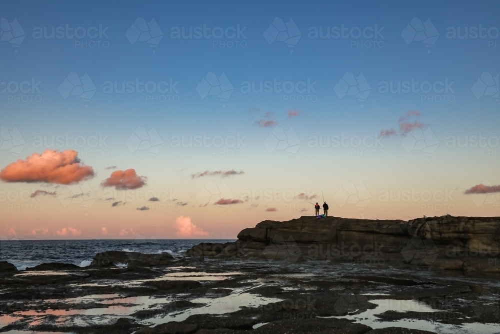 People fishing from rocks at Norah Head, New South Wales Australia - Australian Stock Image