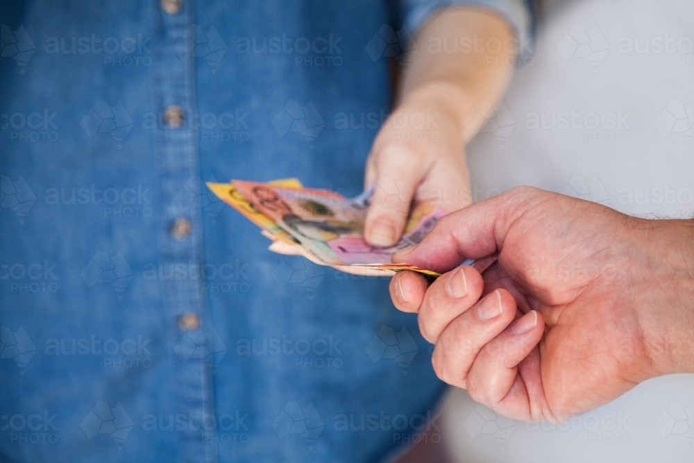 Image of People handing over Australian money notes in payment ...